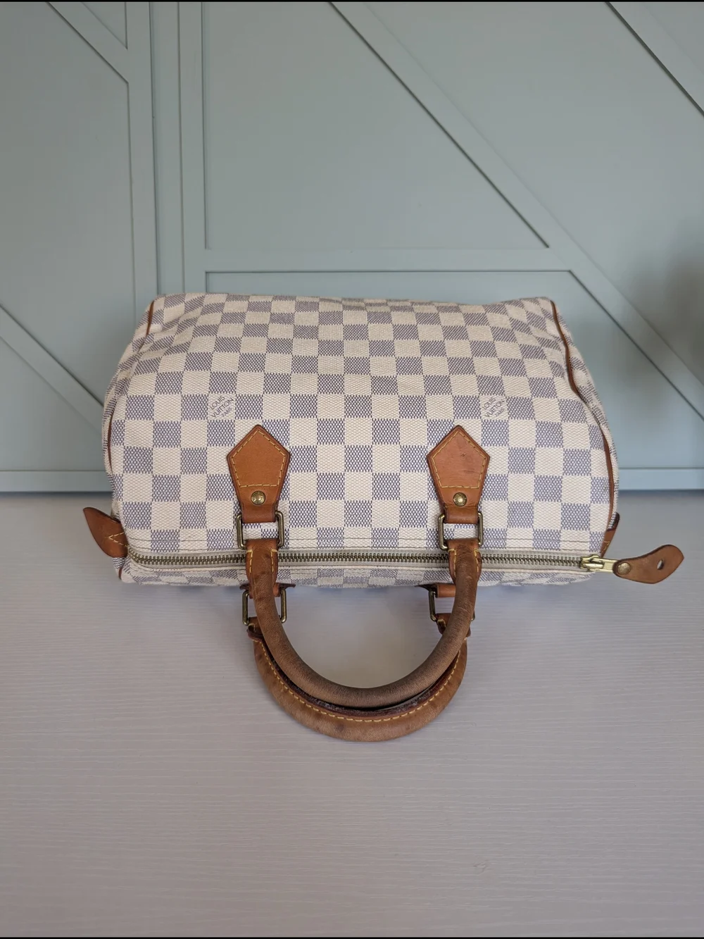 Louis Vuitton Speedyhandbag styled in the iconic Damier Azur canvas pattern.
